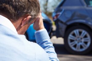 Upset driver at roadside after car accident